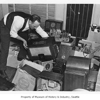 Man stacking radios surrendered by Japanese Americans, Seattle, December 29, 1941